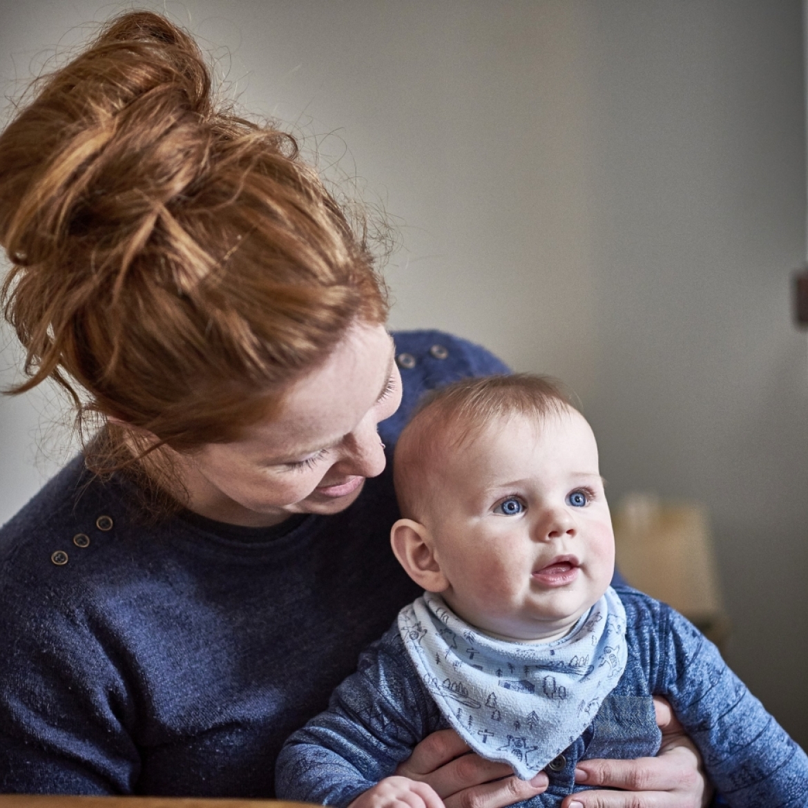 mother holding her child happily 